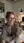 Redhead in blazer lying on office desk selfie