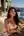Brunette in white tank top on villa terrace