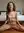 Calista in dim bedroom light, dark wavy hair flying as she rides hard
