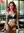 Redhead leans forward in cafe