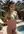 Bikini top pulled down poolside