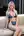 Blonde lounging on couch in blue micro bikini