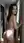 Brunette nude hallway over-shoulder glance