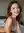 Nude brunette smiling in bed