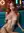 Redhead squeezes breast on neon couch