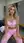 Curvy blonde in pink activewear on locker bench
