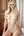 Nude blonde on bed edge