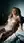 Nude blonde reclines in bedroom