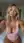 High angle selfie curvy blonde in pink bodysuit on bed