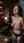 Topless brunette smiling in wine cellar