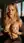 Blonde at desk lifting breasts