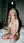 Curvy blonde kneeling nude on bed
