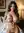 Nude in cozy bedroom squeezing breasts