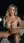 Blonde cupping breasts on balcony