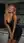 Curvy blonde leans on kitchen counter