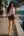 Brunette wavy hair brown eyes poolside look back