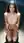 Nude on wet sand knees together