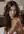 Brunette topless on bed close up
