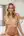 Nude blonde sits on bed