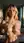 Blonde cupping breasts bathroom mirror