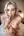 Nude blonde kneeling in bedroom
