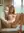 Slim nude blonde spreads on couch