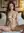 Nude on white bed in hotel room