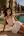 Young adult brunette poolside in white tank top
