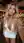 Young curvy blonde deep cleavage mini dress bar selfie