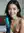 Brunette holds dildo in bedroom