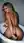 Nude blonde in bath gripping plug