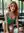 Curvy redhead leans in cafe